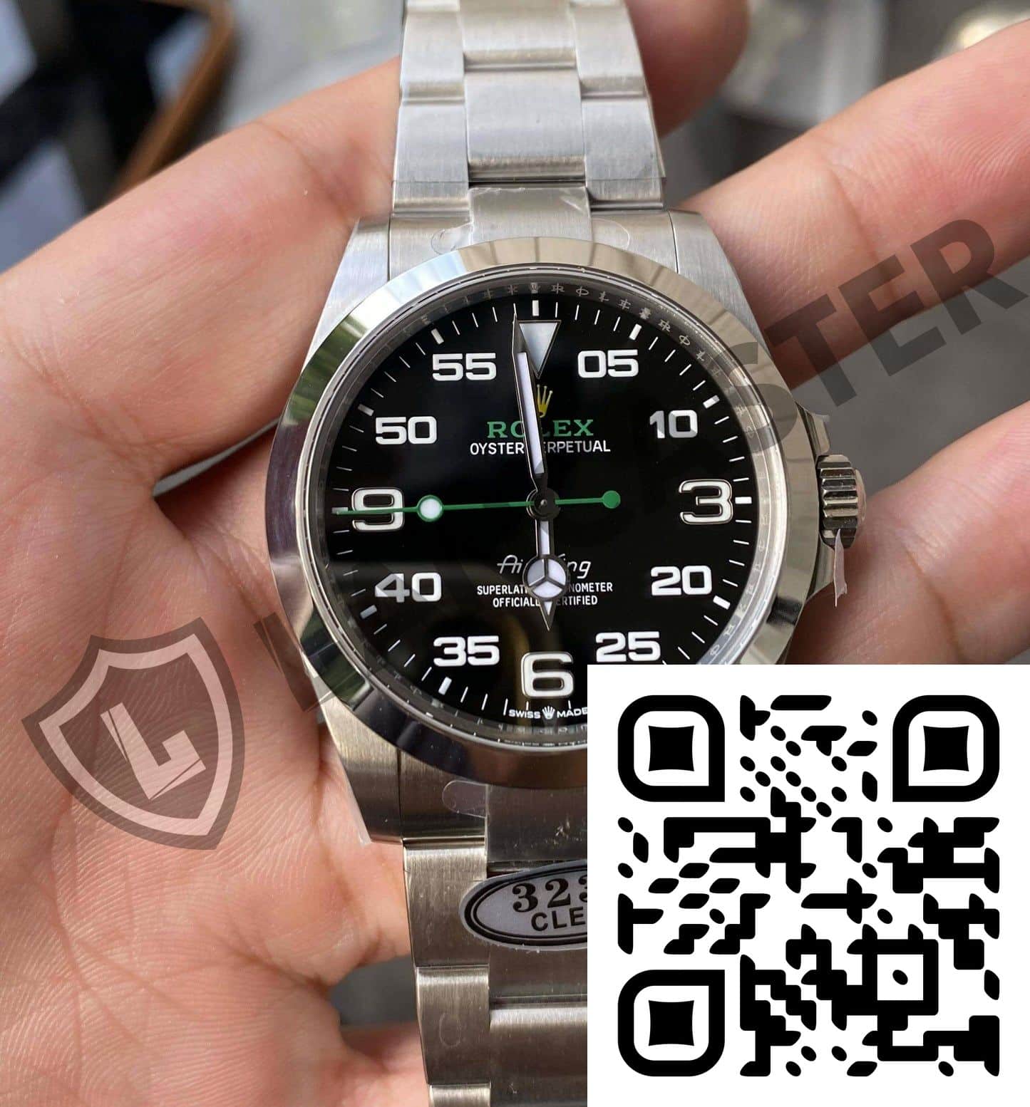 a hand holding a silver watch