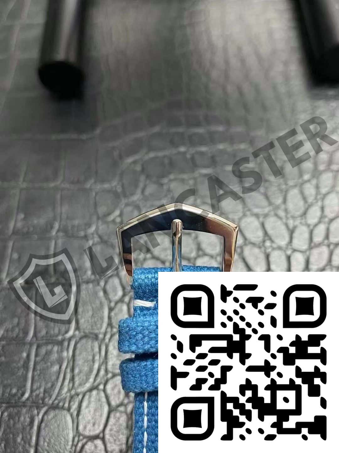 a qr code on a black leather surface